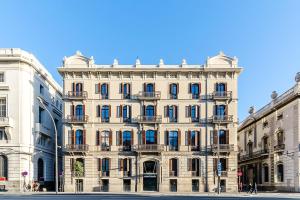 ein großes weißes Gebäude in einer Stadtstraße in der Unterkunft Hotel Ciutadella Barcelona in Barcelona