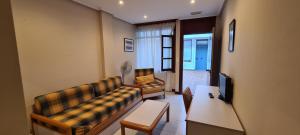 a living room with a couch and a table at Apartamentos Elena in Laredo