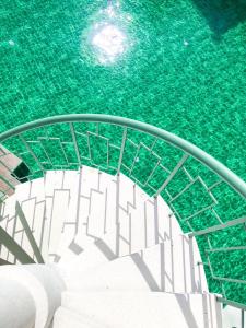 a pool of water with stairs in a stadium at Supicha Pool Access Hotel - SHA Plus in Phuket