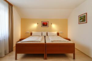 a bed in a room with two pillows on it at Ferienwohnung Irmi in Hergensweiler