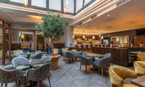 a restaurant with tables and chairs and a bar at Grand Hotel in Malahide
