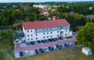 an overhead view of a building with a parking lot at Hotel Szeghalom in Szeghalom