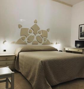 a bedroom with a large bed and a tv at Masseria Don Sante in Fasano