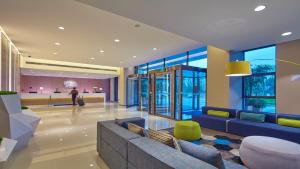 a lobby with a couch and a table in a building at Holiday Inn Express Chongqing University Town by IHG in Chongqing