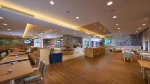 a restaurant with tables and chairs and a bar at Holiday Inn Express Chongqing University Town by IHG in Chongqing