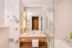 a bathroom with a sink and a shower at Holiday Inn Hamburg, an IHG Hotel in Hamburg