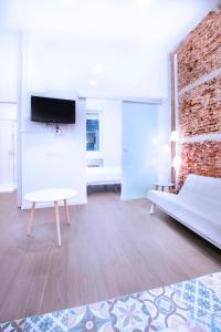 un soggiorno con divano e TV a parete di Fancy One-bedroom La Latina a Madrid