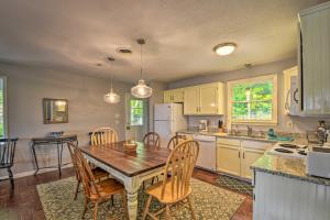 a kitchen with a table and chairs in a room at Smoky Mountain Home on 20-Acre Lot with Poker Room! in Franklin