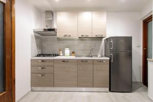 a kitchen with a stainless steel refrigerator at Porta della Musa in Ascoli Piceno