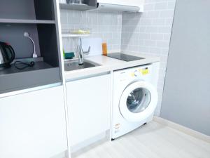 a laundry room with a washer and dryer at ARA Palace Hotel in Jeju