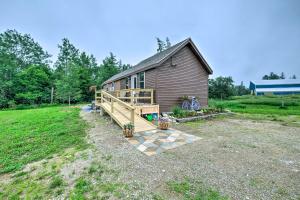 a small house with a porch and a deck at Historic Cottage on Horse Farm FirePit and BBQ in Milbridge