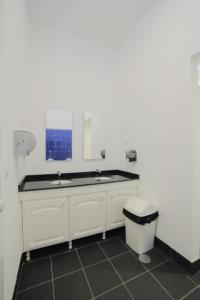a bathroom with two sinks and a toilet at Santa Maria Hostel in Funchal
