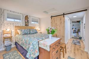 een slaapkamer met een bed en een dressoir met bloemen erop bij Historic Cottage on Horse Farm FirePit and BBQ in Milbridge