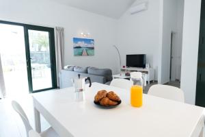 a white table with a bowl of food on it at casa sea front costa teguise in Costa Teguise