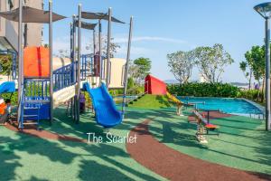 a playground with a slide and a swimming pool at The Scarlet @ Sunway Gandaria in Kampong Sungai Ramal Dalam