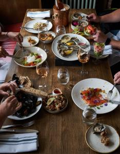 a table with plates of food and glasses of wine at The Mitre, Hampton Court in Kingston upon Thames