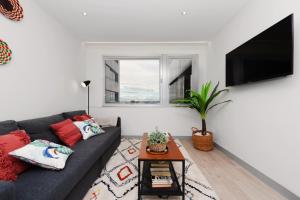 a living room with a couch and a tv at 2 bedrooms 1 bathroom furnished - Justicia - Executive style - MintyStay in Madrid