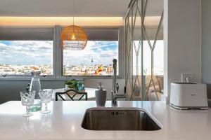 a kitchen with a sink and a large window at 2 bedrooms 1 bathroom furnished - Justicia - incredible views - MintyStay in Madrid