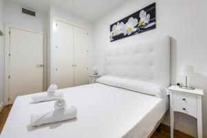 ein weißes Schlafzimmer mit einem großen Bett mit Handtüchern darauf in der Unterkunft Central and modern- 2 bedrooms 1 bathroom - MintyStay- Sol in Madrid