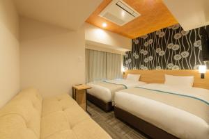 Tempat tidur dalam kamar di Tosei Hotel Cocone Ueno Okachimachi