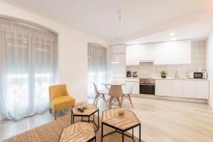 eine weiße Küche mit einem Tisch und Stühlen im Zimmer in der Unterkunft Bright and modern- 2 bedrooms 1bathroom- MintyStay - Bocángel in Madrid
