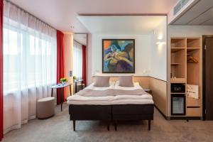 Postel nebo postele na pokoji v ubytování Art Hotel Pallas by Tartuhotels