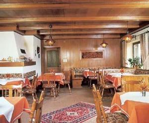 a dining room with tables and chairs in a restaurant at Pension & Fewos Fuchs in Mauth