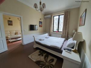 a small bedroom with a bed and a window at Presidency House Self Check-in Apartments in Sofia