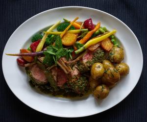 a plate of food with meat and vegetables on a table at The Mitre, Hampton Court in Kingston upon Thames