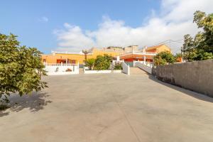 an empty parking lot in front of a building at Casa Marjoes - 2 Villas - BBQ - Communal Pool in Moya