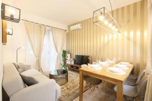 a living room with a dining room table and a couch at MintyStay - Toledo in Madrid