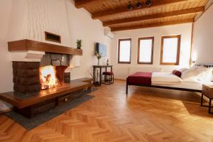 a bedroom with a fireplace and a bed at Grand Boutique Hotel in Prishtinë