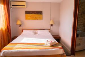Postel nebo postele na pokoji v ubytování Java Hotel