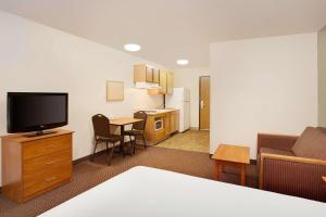a hotel room with a bed and a television at WoodSpring Suites Chesapeake-Norfolk South in Chesapeake