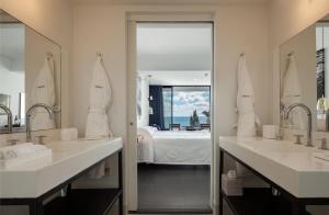 
a bathroom with a sink and a mirror at Almyra in Paphos City
