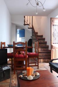 a living room with a table and a staircase at Casa Sonrisa in Guaro