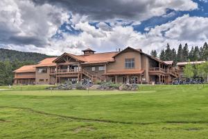 a large house with a green lawn in front of it at Modern Mountain Retreat with Views Ski, Golf and Hike in Angel Fire