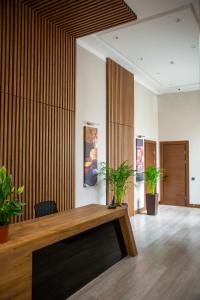 a room with a wooden table and some plants at Prime Suites Bulvar in Baku