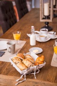 un tavolo con un piatto di croissant e pane sopra di La Demeure de Cybele - chambres d'hôtes en Drôme Provençale a Colonzelle