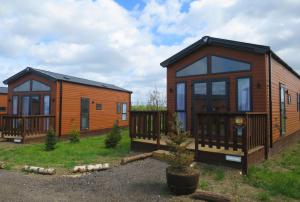 two modular homes in a yard with a fence at Gulliver's Valley, M1, JCT 31 in Rotherham