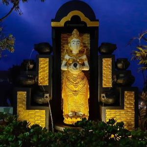 a statue of a god with a camera in front at Bromo Otix Guest House in Bromo