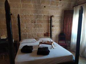 a bedroom with a bed with two bags on it at Suite Sant'Irene in Veglie