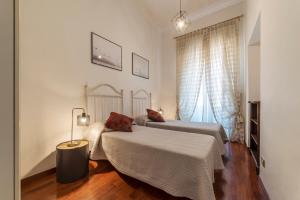 En eller flere senge i et værelse på Piazza del Popolo Elegant Apartment