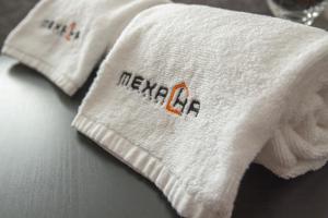 a white towel with the word new ac on it at Mehana apartmani in Leskovac