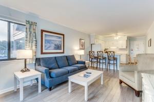 a living room with a blue couch and a table at Unforgettable Vacation Experience at Ocean Forest Villas in Myrtle Beach