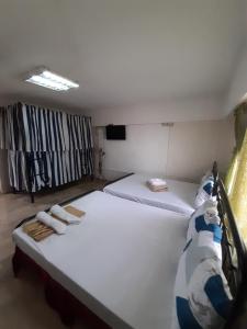 A bed or beds in a room at OYO 695 Bcd 58 Ohana Hostel