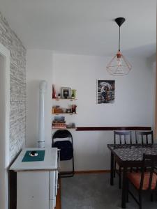 a living room with a table and a white wall at Holiday Home Stella in Vrdnik