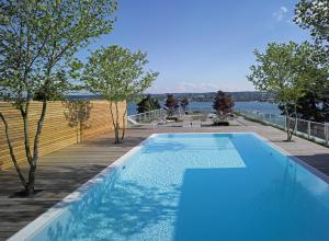 a blue swimming pool on top of a house at RIVA - Das Hotel am Bodensee in Konstanz