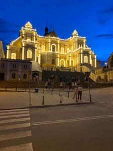 a large building with people standing in front of it at U Eli in Wambierzyce
