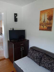 a bedroom with a bed and a flat screen tv at Holiday Home Stella in Vrdnik